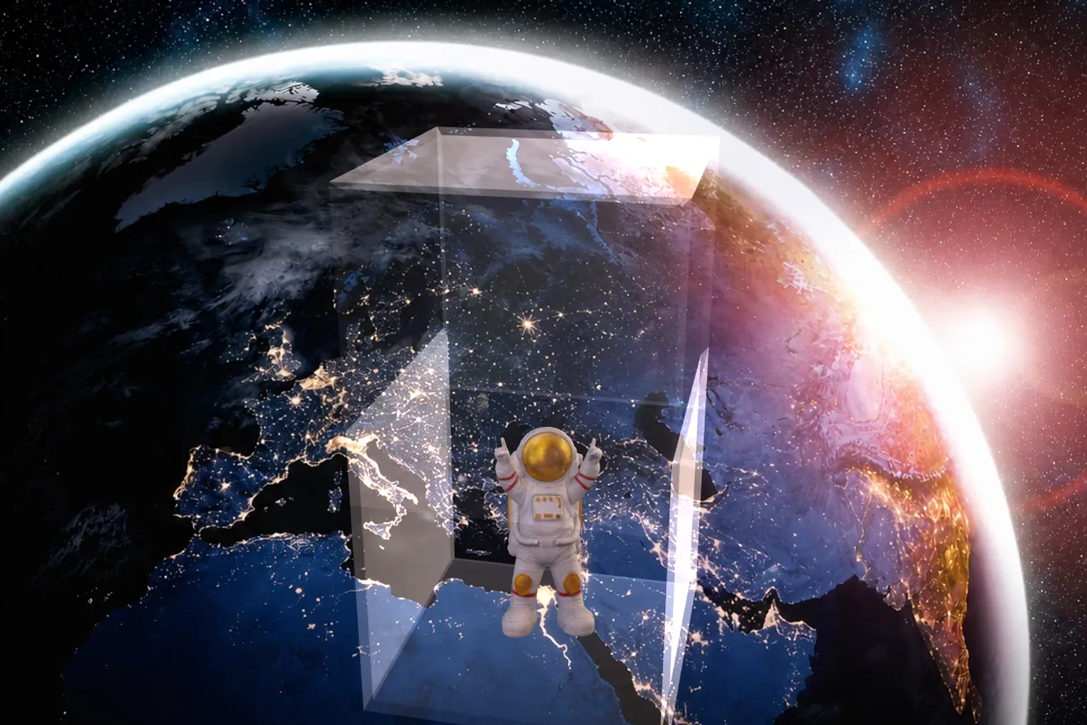 透明なミノルキューブの中に浮かぶ宇宙飛行士。背景には地球。